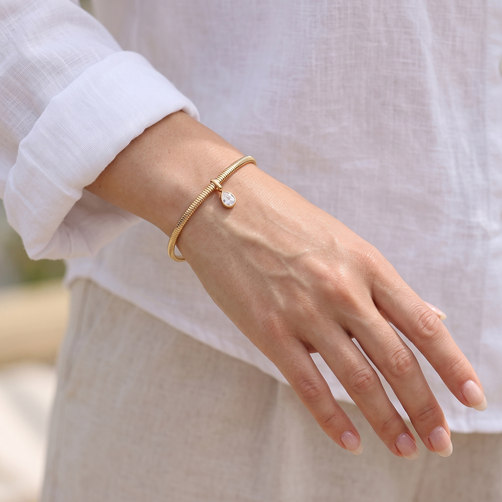 Stainless steel bangle, 6.2 cm, gold-coloured with teardrop-shaped cubic zirconia 