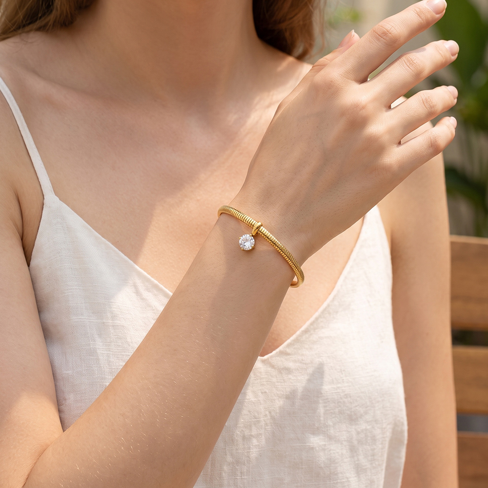 Stainless steel bangle, 6.2 cm, gold-coloured with round cubic zirconia