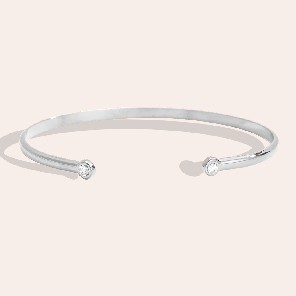 Stainless steel bangle, adjustable, with two plain cubic zirconia stones