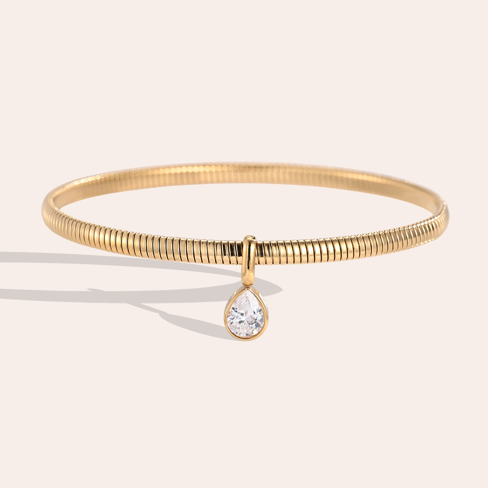 Stainless steel bangle, 6.2 cm, gold-coloured with teardrop-shaped cubic zirconia 