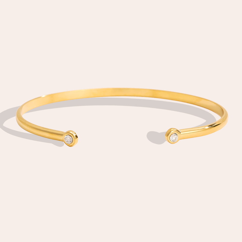 Stainless steel bangle, adjustable, with two plain cubic zirconia stones
