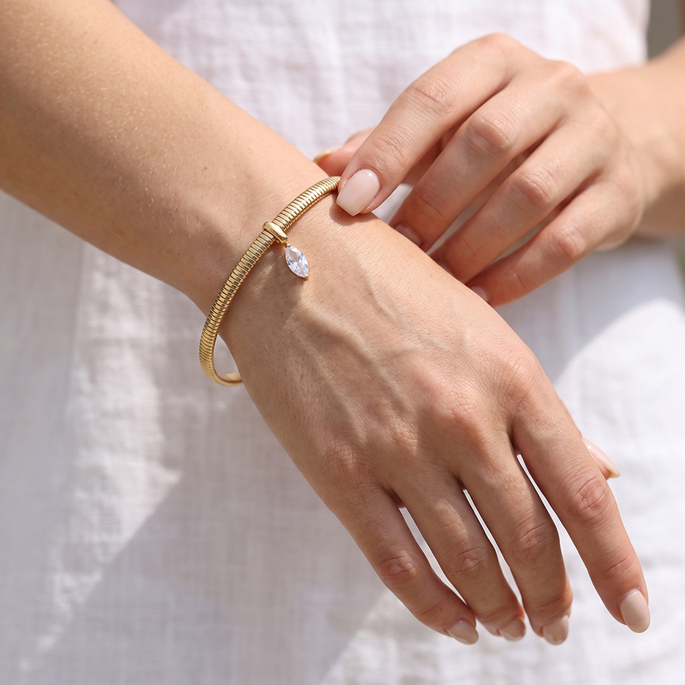 Stainless steel bangle, 6.2 cm, gold-coloured with eye-shaped cubic zirconia